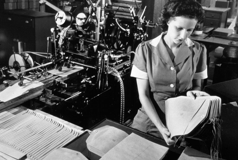 An associate performs a quality check on the popular "Tension Tie" envelope.